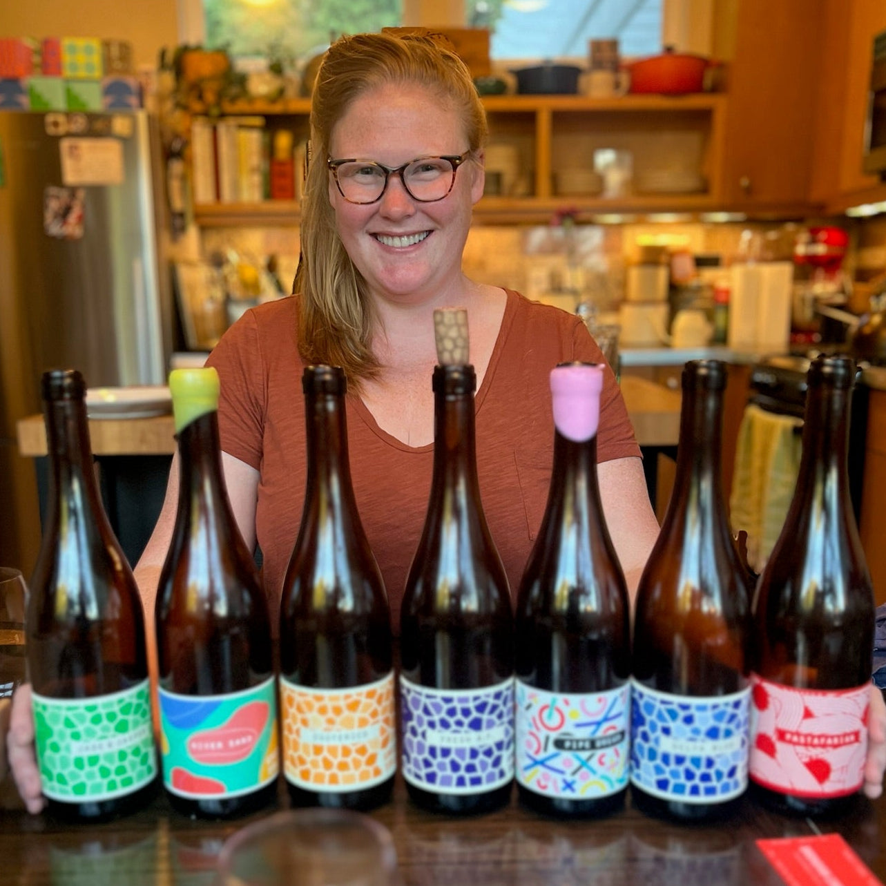 seattle-based sommerlier Alexa Skilling stands behind a row of sustainable wines.